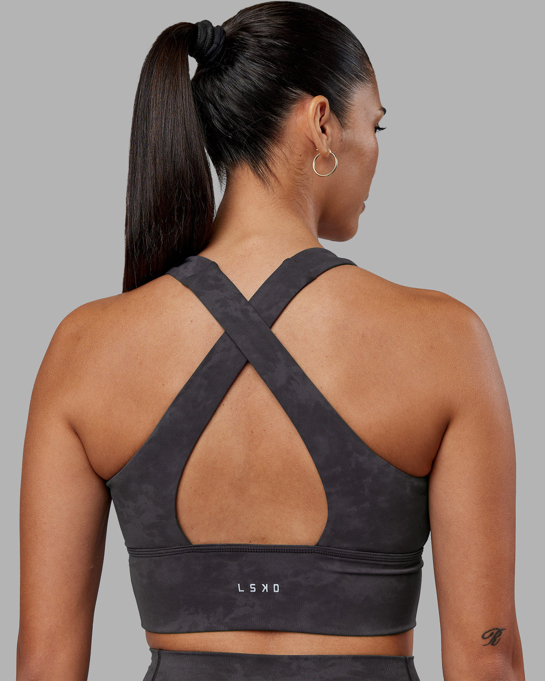 Woman wearing Evoke Longline Sports Bra - Dark Storm Wash | Model:Rhiley | Size:S