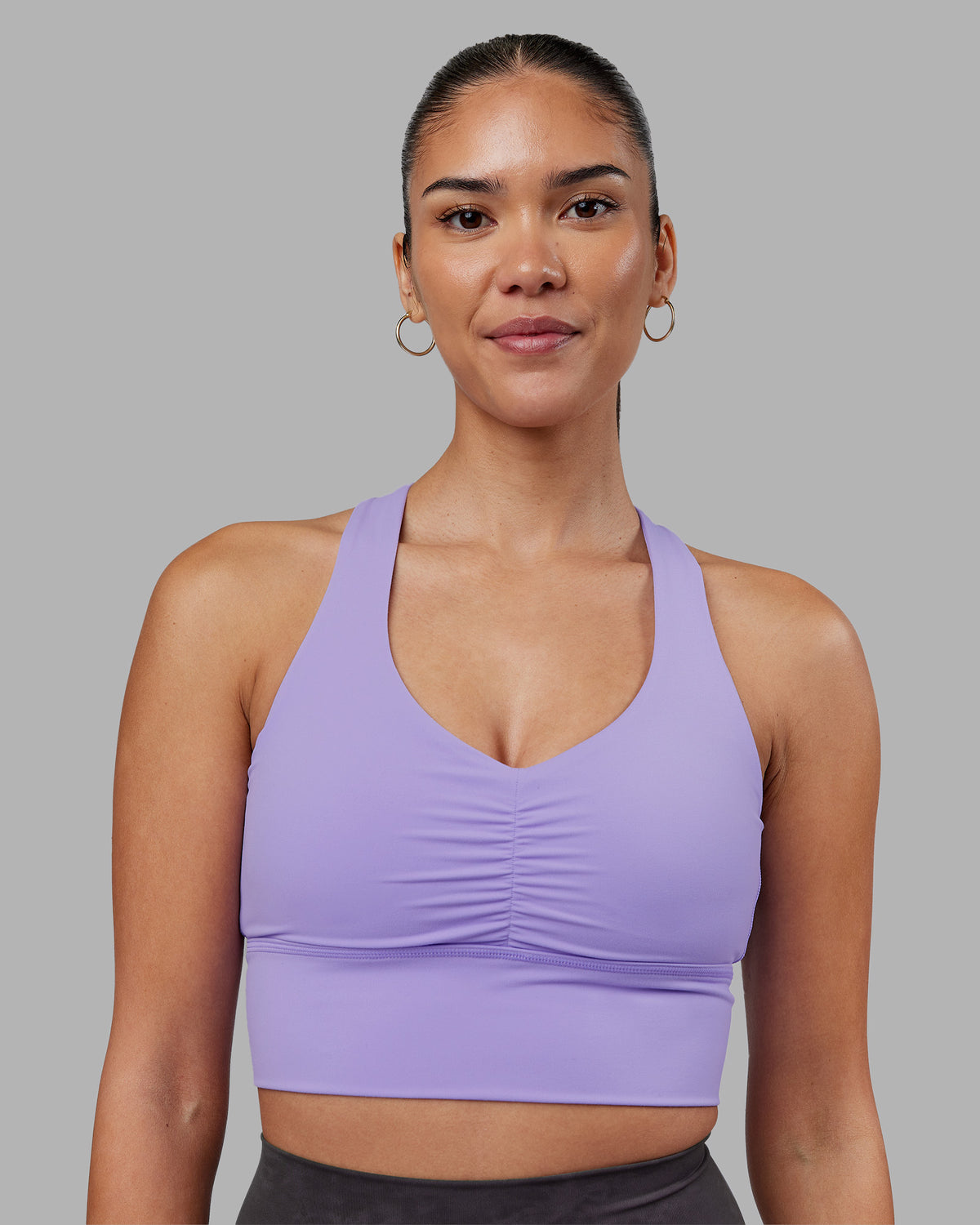 Woman wearing Evoke Longline Sports Bra - Violet Ray | Model:Rhiley | Size:S
