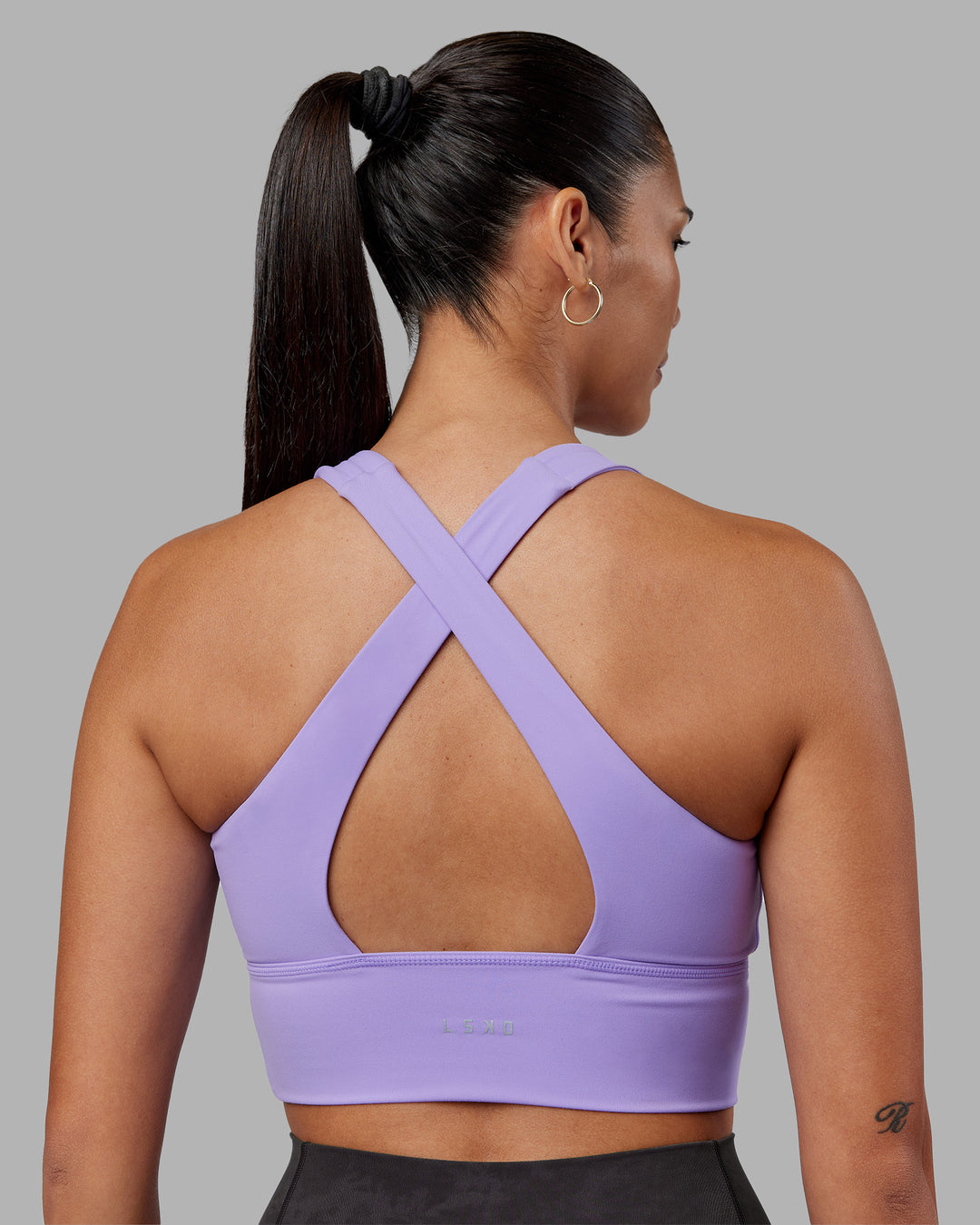 Woman wearing Evoke Longline Sports Bra - Violet Ray | Model:Rhiley | Size:S