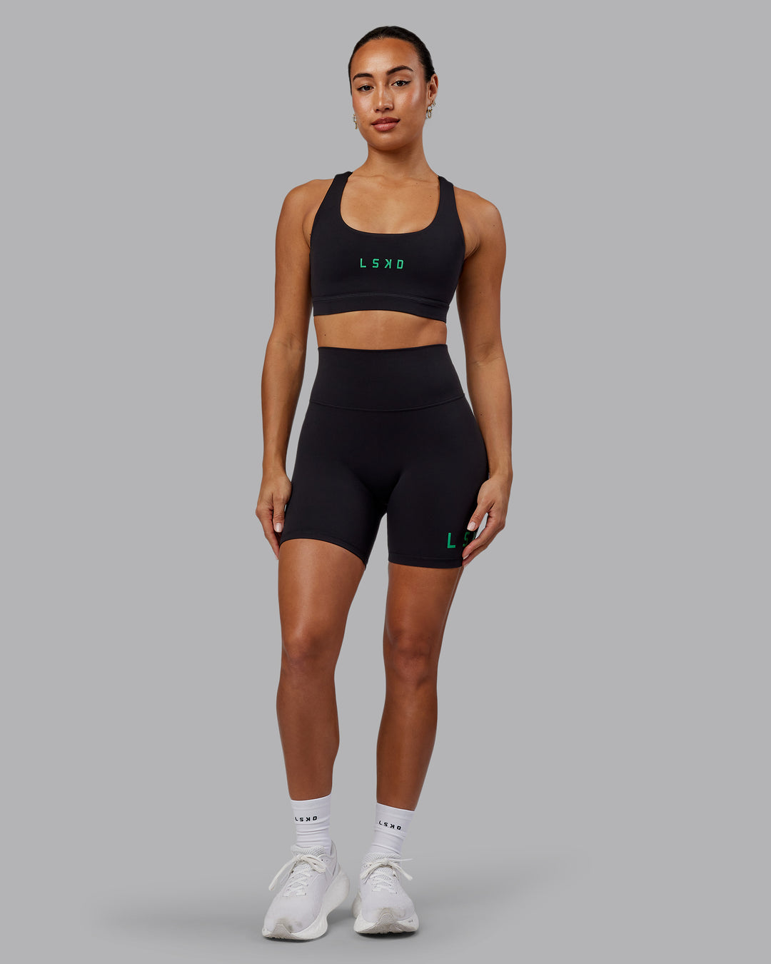Woman wearing Evolved Ultra High-Rise 6&quot; Short - Black-Impact Green