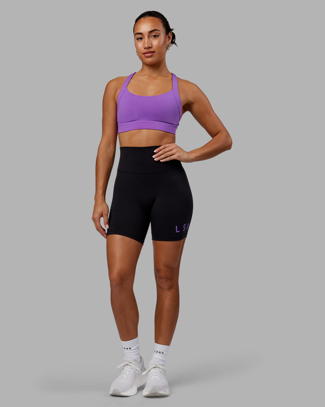 Woman wearing Evolved Ultra High-Rise 6&quot; Short - Black-Purple Swirl