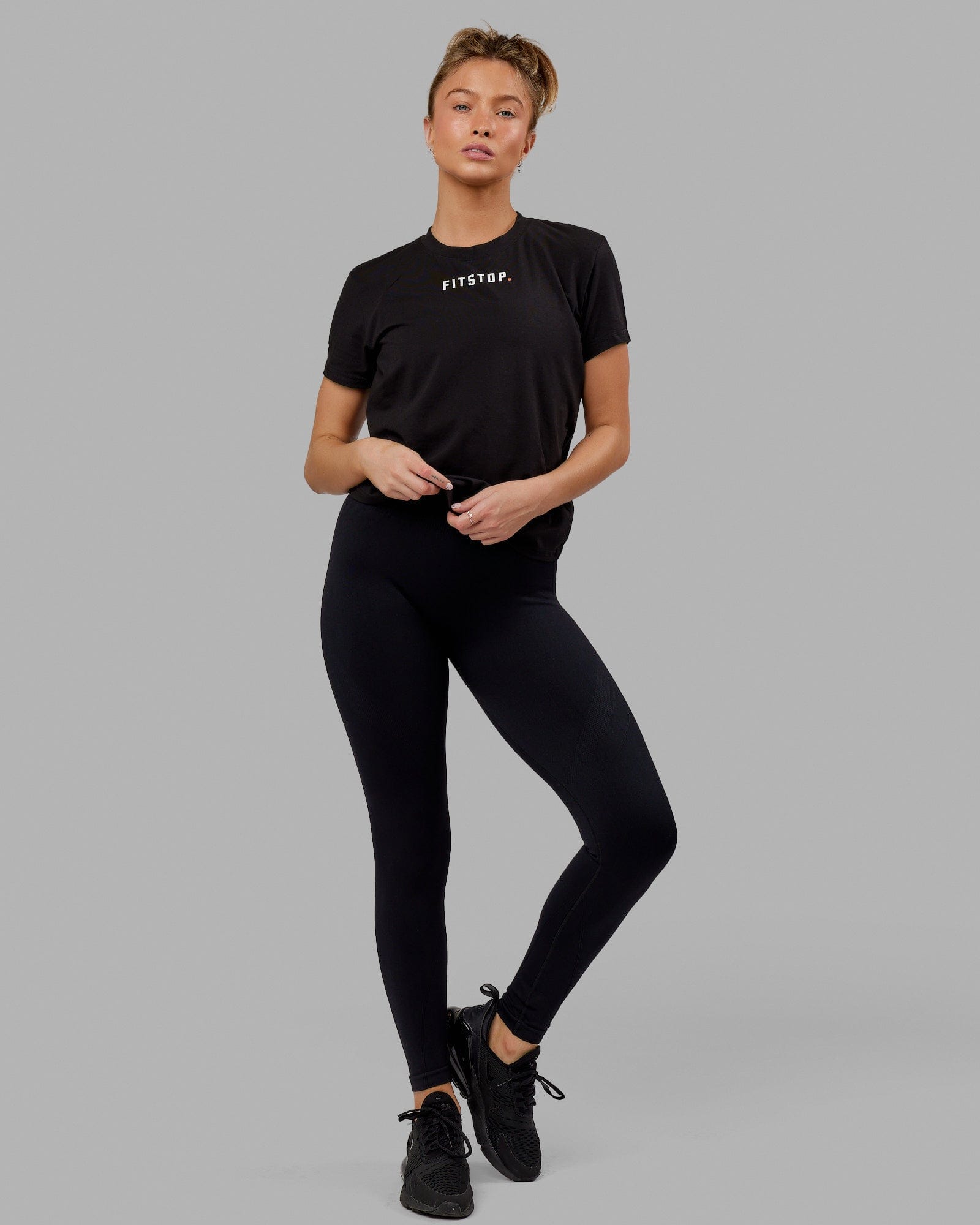 Woman wearing Fitstop Fast Tee - Black