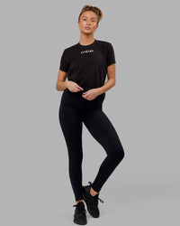 Woman wearing Fitstop Fast Tee - Black