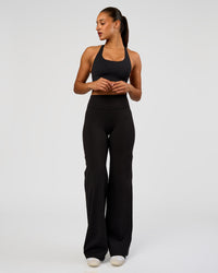 Woman wearing Flow Bonded Scoop Neck Sports Bra - Black | Model:Rosie | Size:S