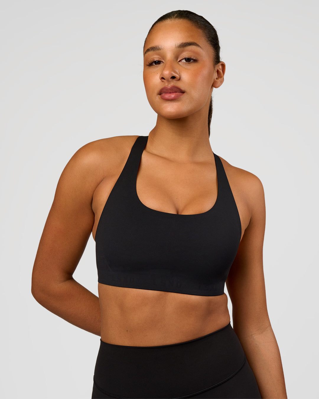 Woman wearing Flow Bonded Scoop Neck Sports Bra - Black | Model:Rosie | Size:S