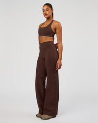 Woman wearing Flow Bonded Scoop Neck Sports Bra - Hot Chocolate | Model:Rosie | Size:S
