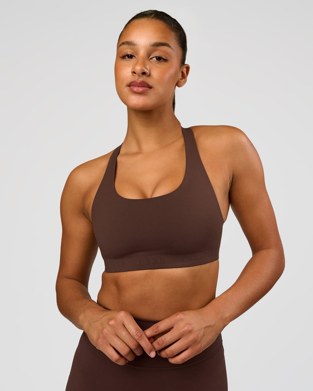 Woman wearing Flow Bonded Scoop Neck Sports Bra - Hot Chocolate | Model:Rosie | Size:S