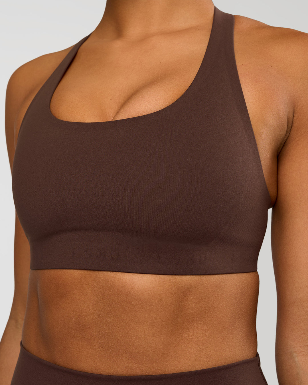 Woman wearing Flow Bonded Scoop Neck Sports Bra - Hot Chocolate | Model:Rosie | Size:S