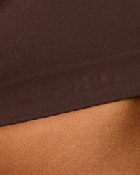 Woman wearing Flow Bonded Scoop Neck Sports Bra - Hot Chocolate | Model:Rosie | Size:S