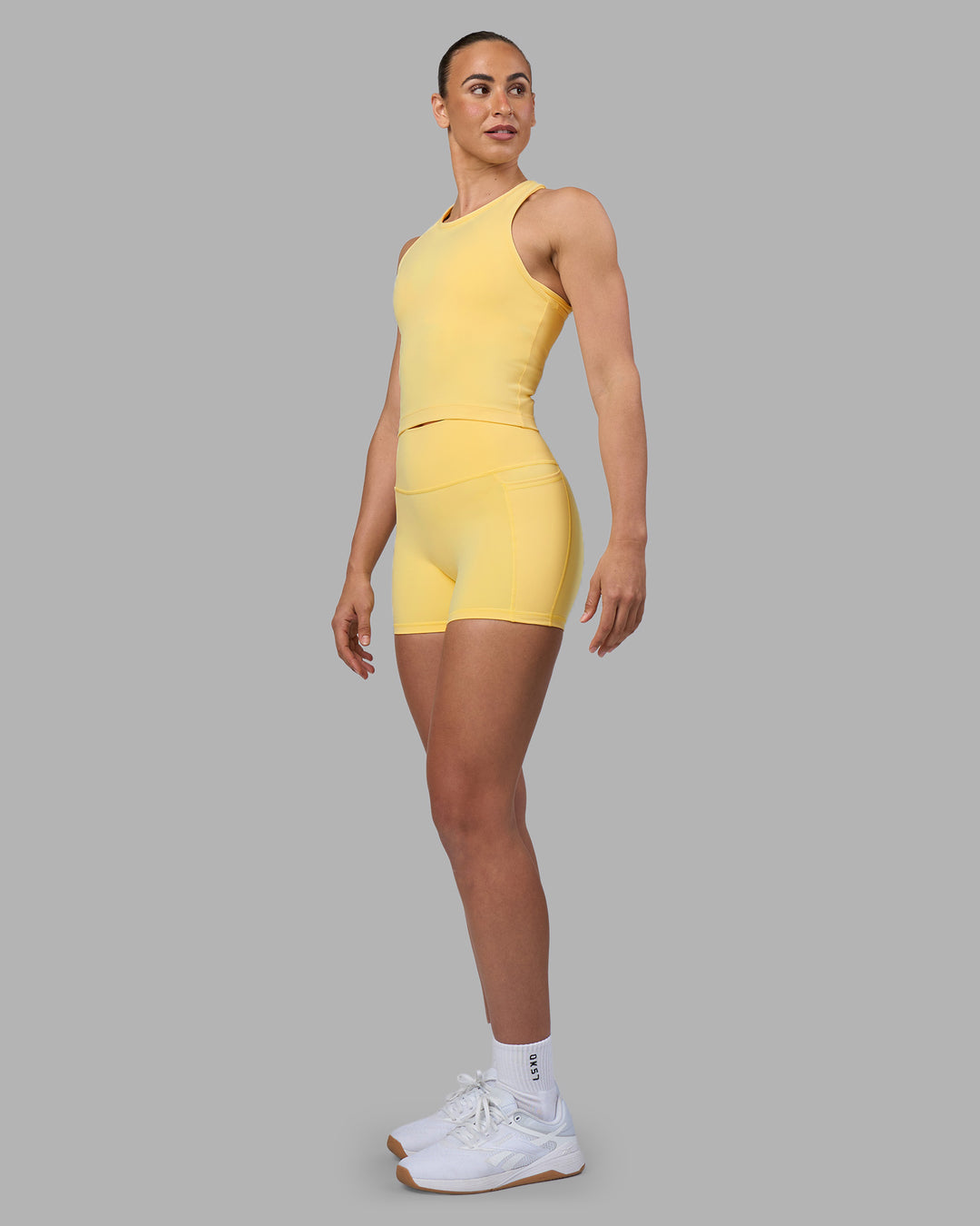Woman wearing Flow Performance Tank 2.0 - Lemon | Model:Sophie | Size:S