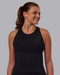 Woman wearing Flow Performance Tank - Black | Model:Phoebe | Size:S