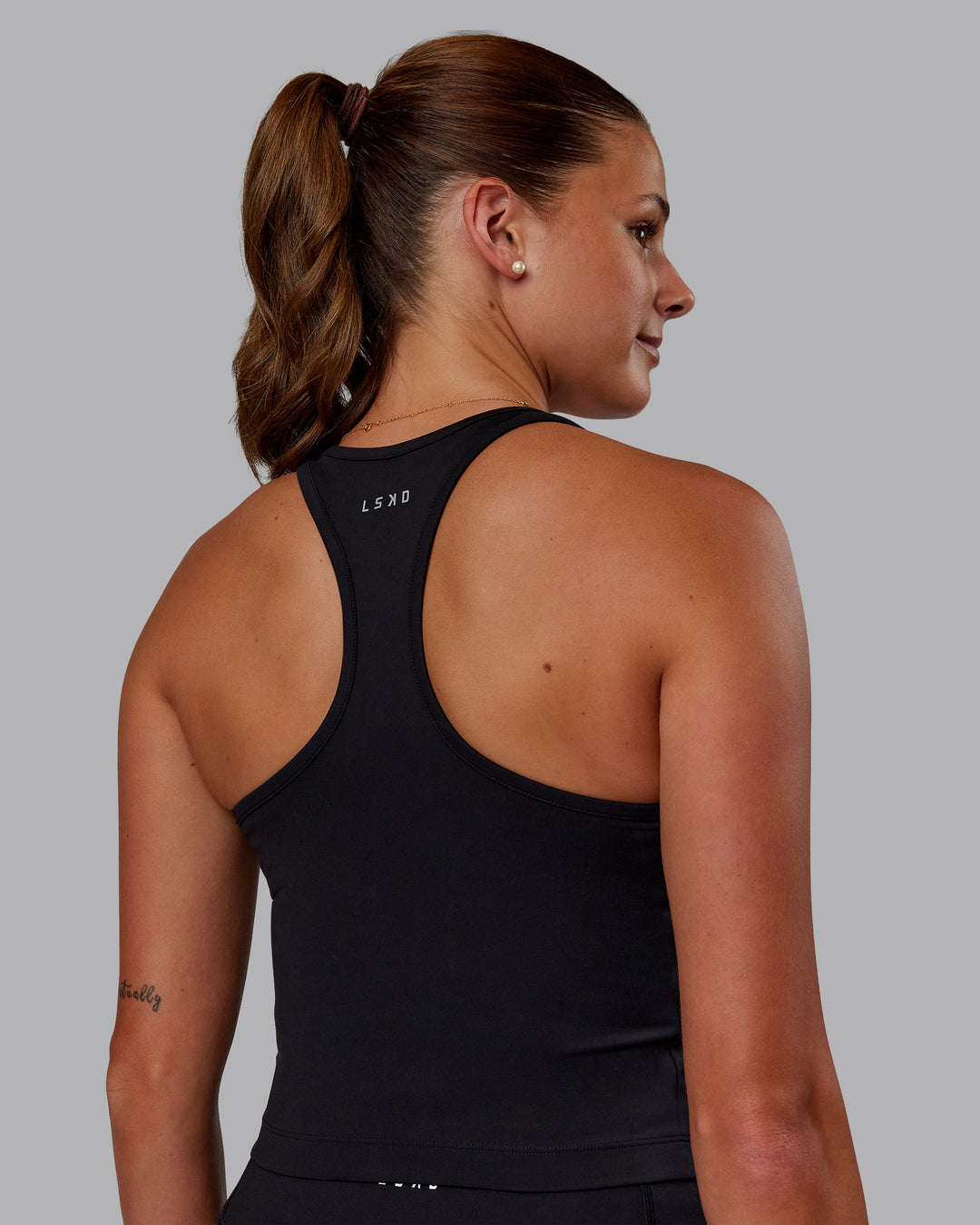 Woman wearing Flow Performance Tank - Black | Model:Phoebe | Size:S