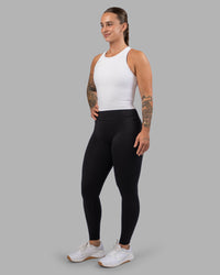 Woman wearing Flow Performance Tank - White | Model:Robyn | Size:S