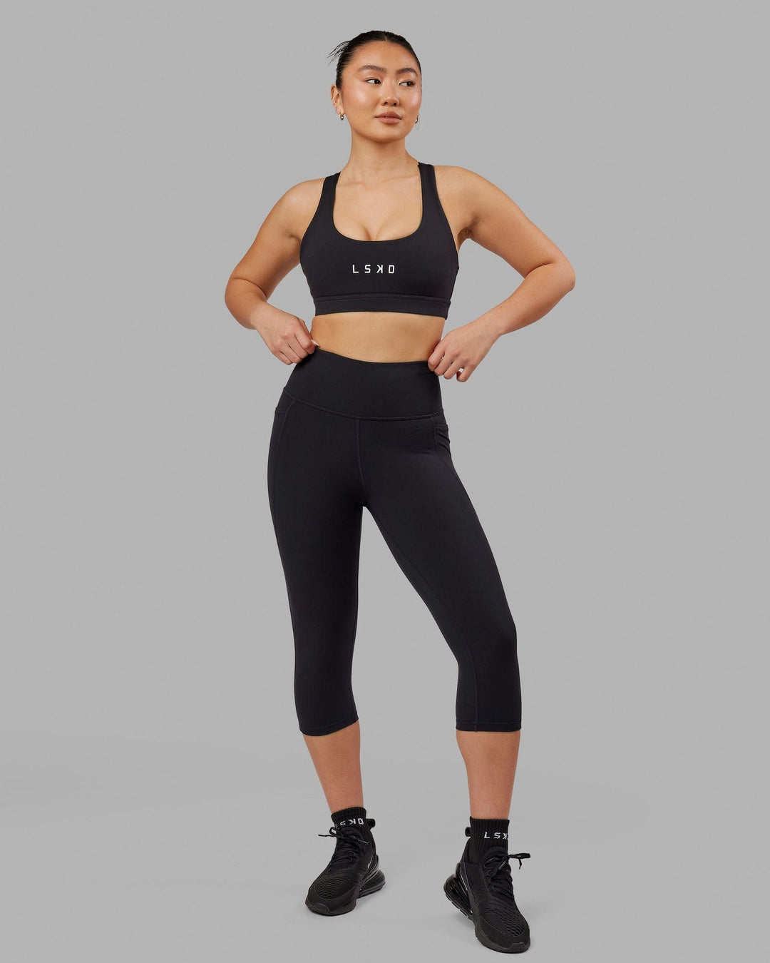 Woman wearing Flux Ultra High-Rise 3/4 Legging Pockets - Black