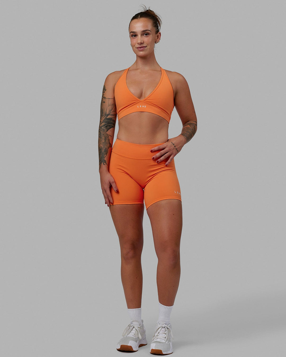 Woman wearing Form Sports Bra - Melon