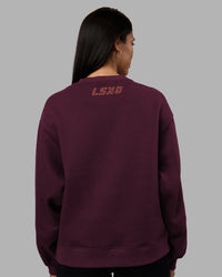 Woman wearing Full Form Fleece Sweater with Side Slits - Cherry Lacquer | Model:Rhiley | Size:S