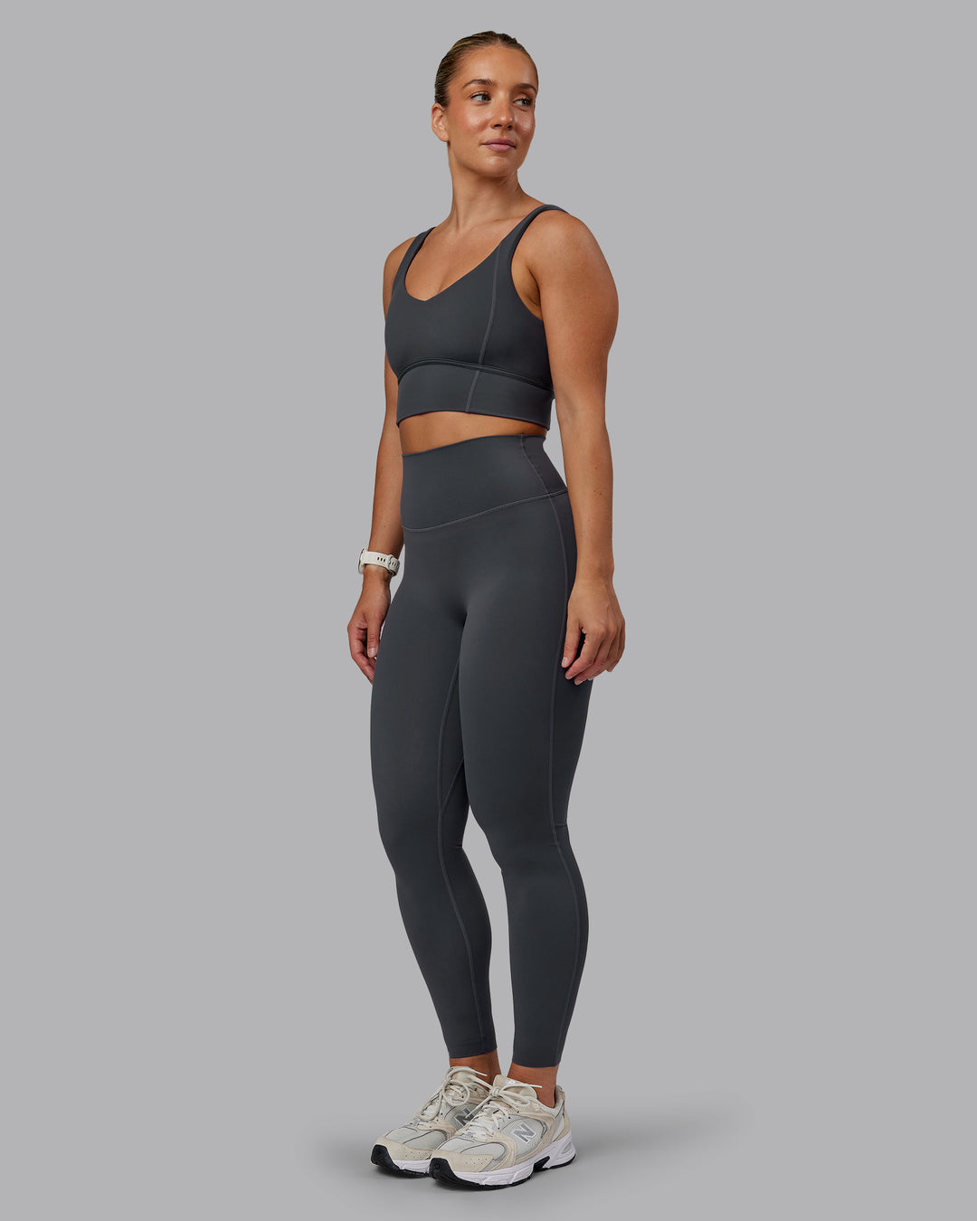 Woman wearing Function Longline Sports Bra in Dark Storm | Size:S