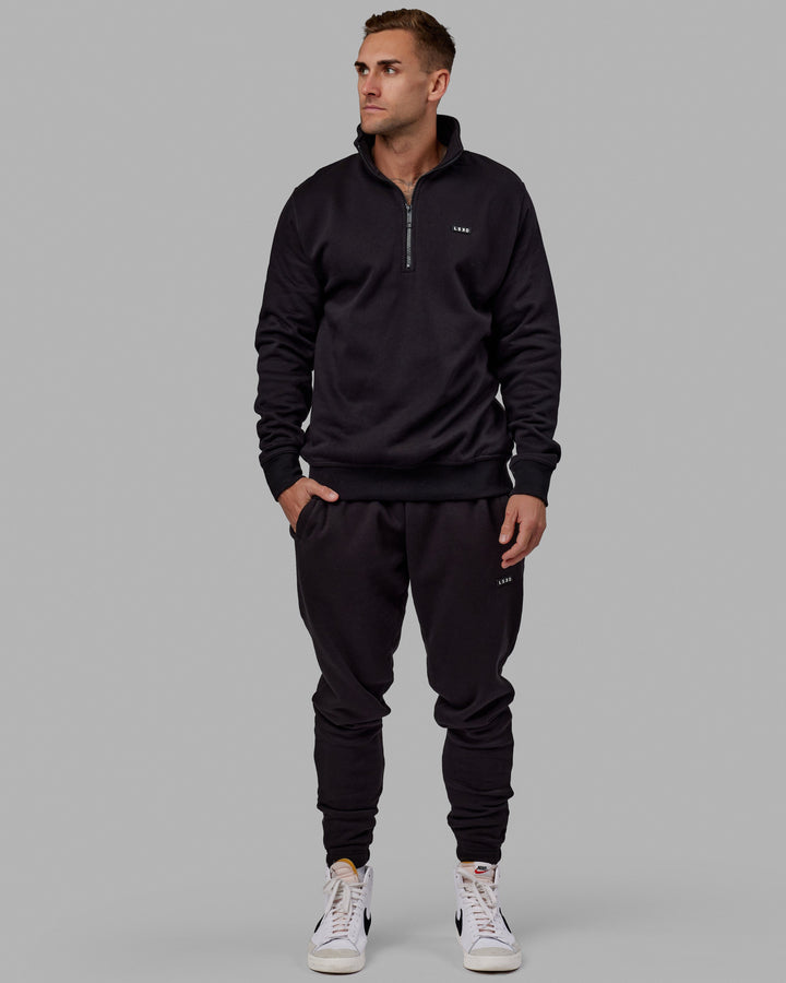Man wearing Unisex Fundamental Track Pant - Black