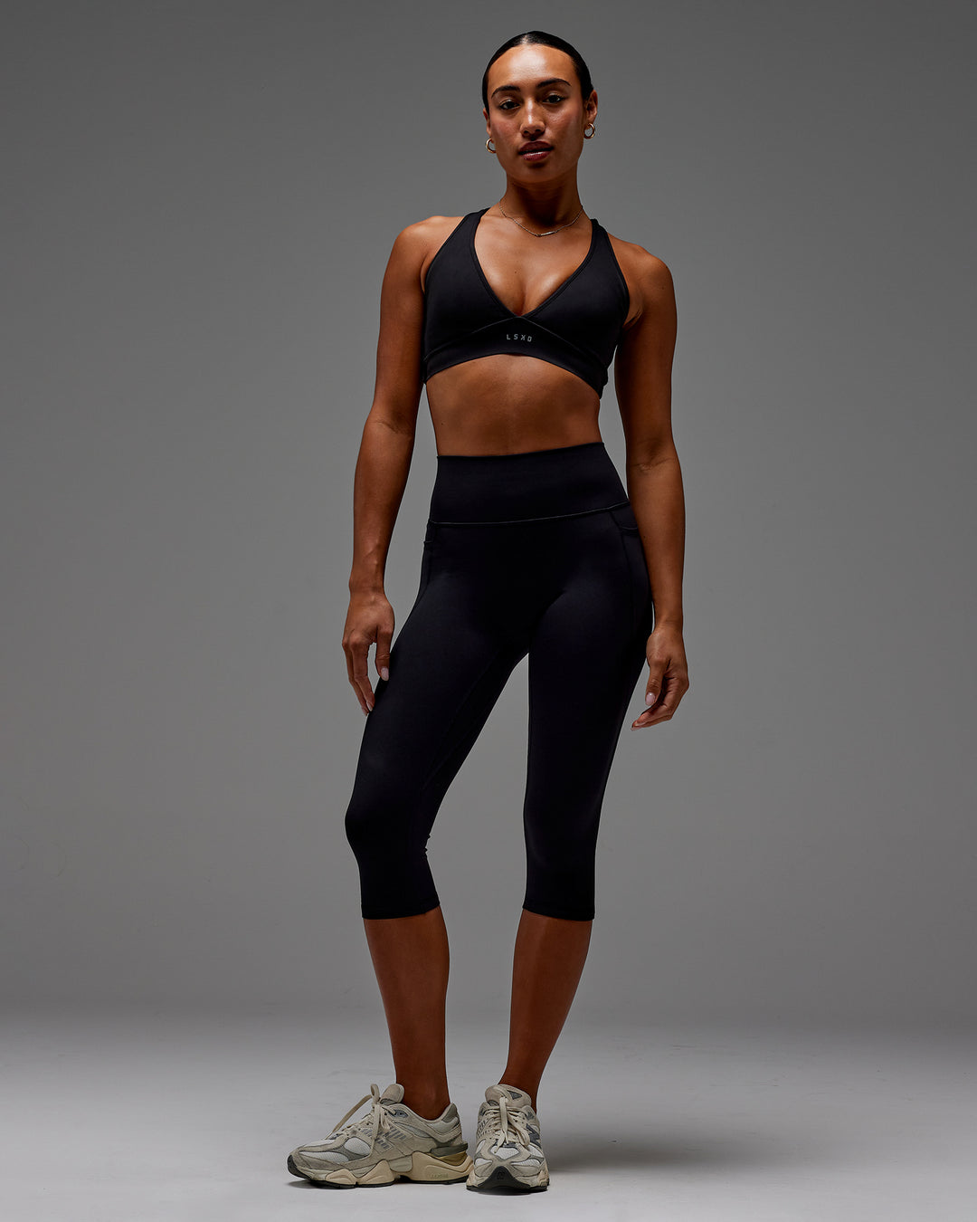 Woman wearing Fusion Ultra High-Rise 3/4 Legging Pockets - Black | Model:Demi | Size:S