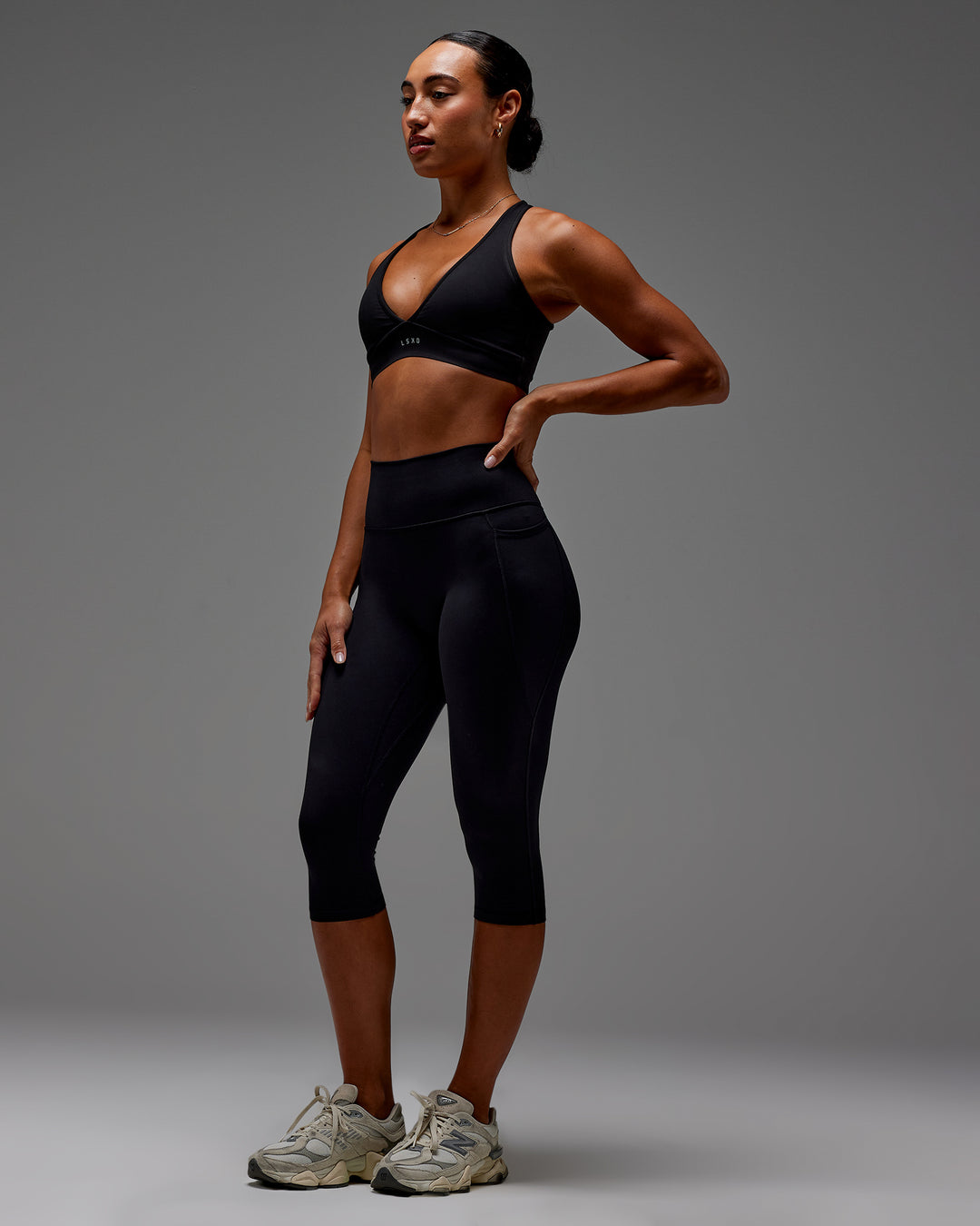 Woman wearing Fusion Ultra High-Rise 3/4 Legging Pockets - Black | Model:Demi | Size:S