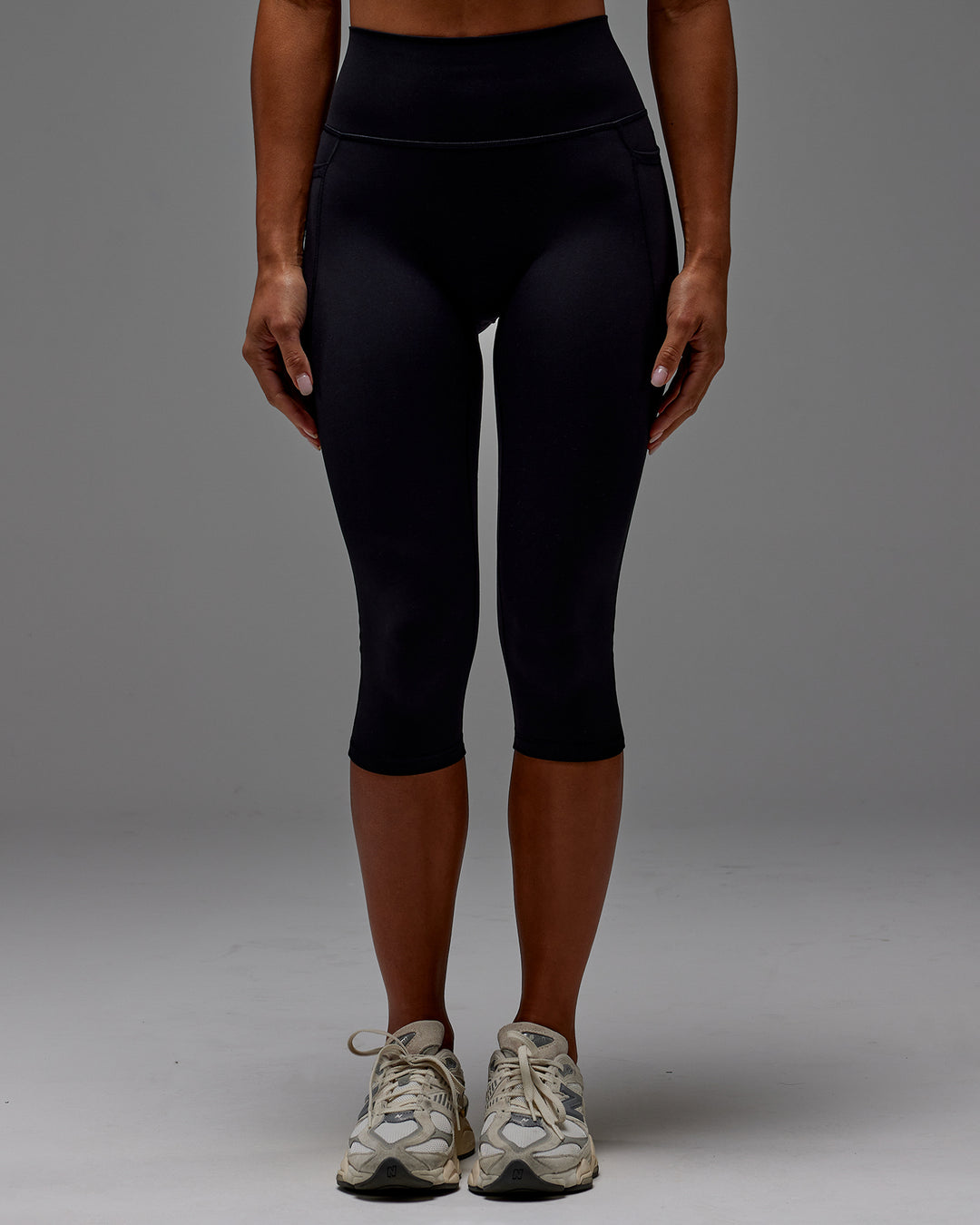 Woman wearing Fusion Ultra High-Rise 3/4 Legging Pockets - Black | Model:Demi | Size:S