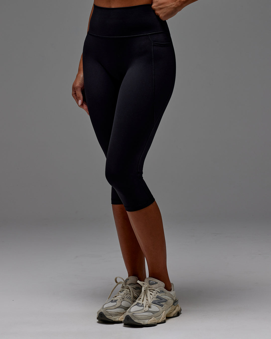 Woman wearing Fusion Ultra High-Rise 3/4 Legging Pockets - Black | Model:Demi | Size:S