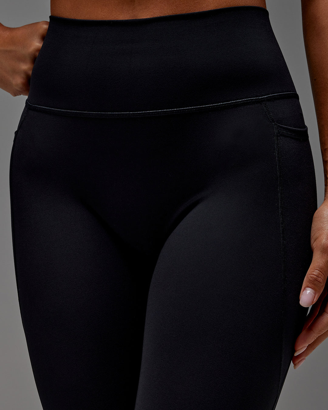 Woman wearing Fusion Ultra High-Rise 3/4 Legging Pockets - Black | Model:Demi | Size:S