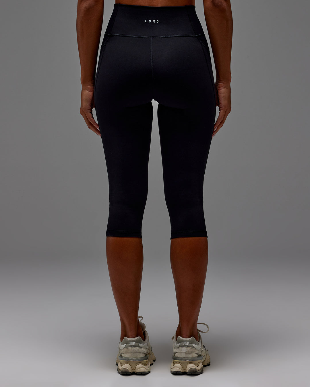 Woman wearing Fusion Ultra High-Rise 3/4 Legging Pockets - Black | Model:Demi | Size:S