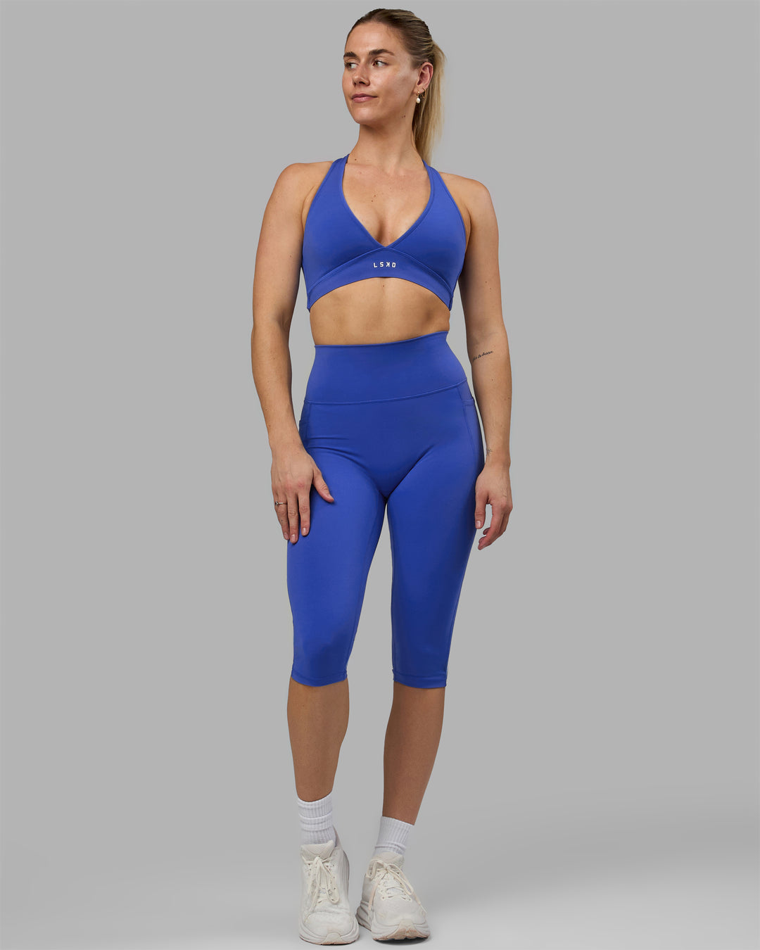 Woman wearing Fusion Ultra High-Rise 3/4 Legging Pockets - Power Cobalt | Model:Hannah | Size:S