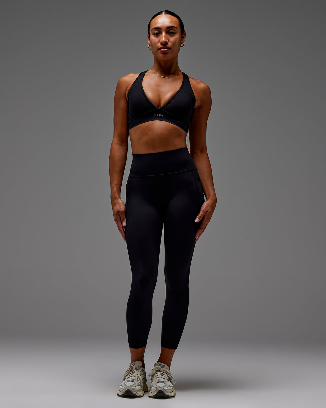 Woman wearing Fusion Ultra High-Rise 7/8 Legging Pockets - Black | Model:Demi | Size:S