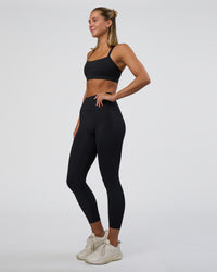 Woman wearing Fusion Ultra High-Rise 7/8 Legging Pockets - Black | Model:Amity | Size:S
