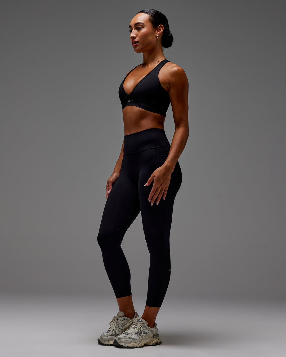 Woman wearing Fusion Ultra High-Rise 7/8 Legging Pockets - Black | Model:Demi | Size:S
