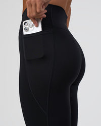 Woman wearing Fusion Ultra High-Rise 7/8 Legging Pockets - Black | Model:Amity | Size:S