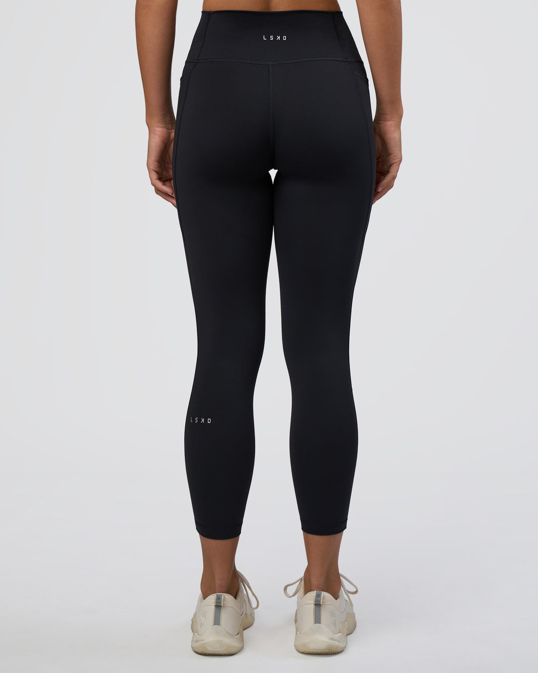 Woman wearing Fusion Ultra High-Rise 7/8 Legging Pockets - Black | Model:Amity | Size:S