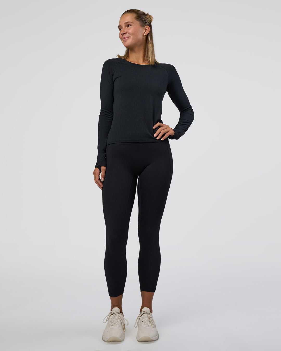 Woman wearing Fusion Ultra High-Rise 7/8 Legging Pockets - Black | Model:Amity | Size:S