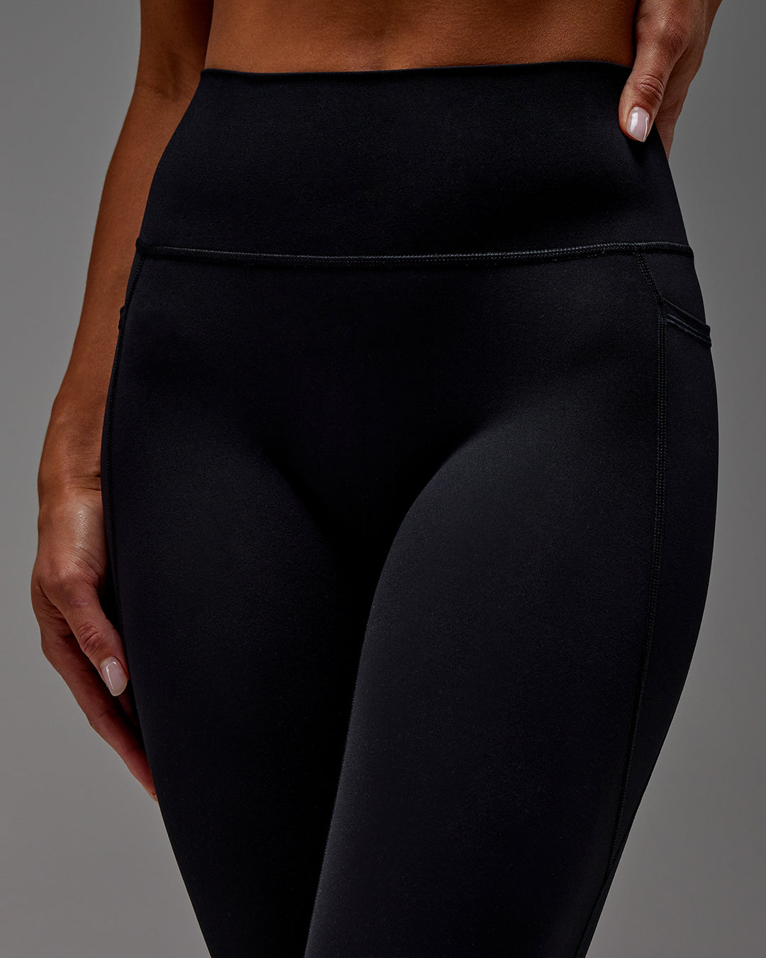 Woman wearing Fusion Ultra High-Rise 7/8 Legging Pockets - Black | Model:Demi | Size:S