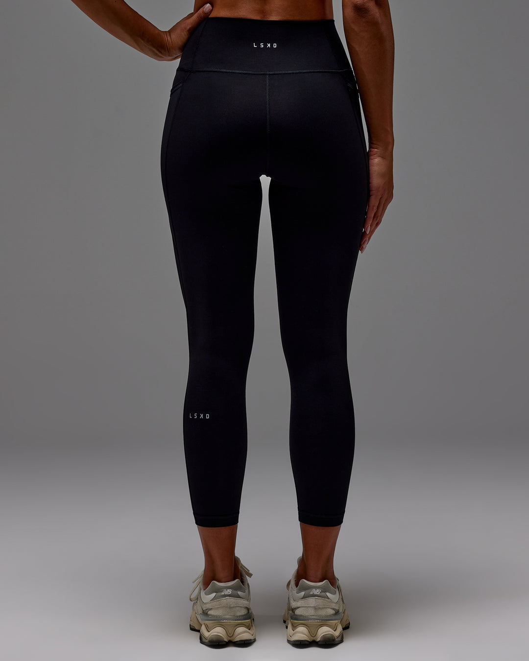 Woman wearing Fusion Ultra High-Rise 7/8 Legging Pockets - Black | Model:Demi | Size:S