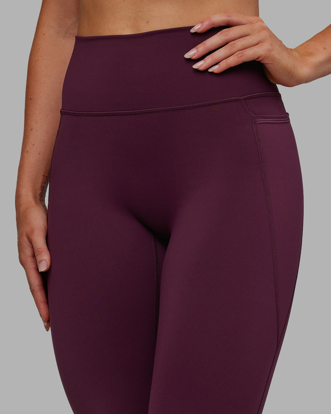Woman wearing Fusion Ultra High-Rise 7/8 Legging Pockets - Cherry Lacquer | Model:Paris | Size:S