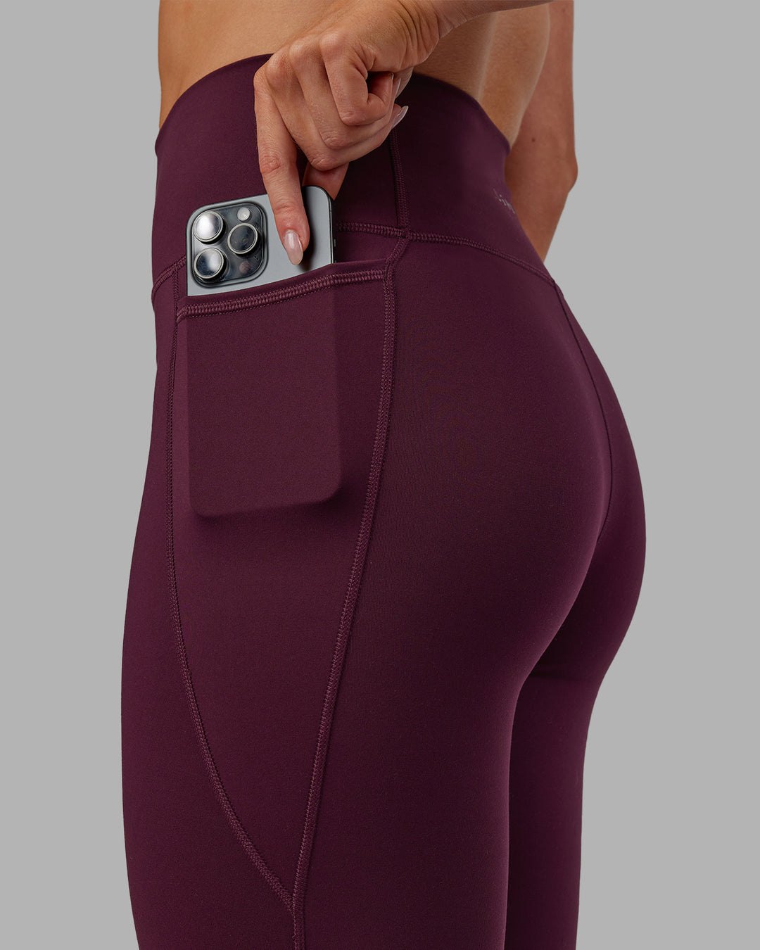Woman wearing Fusion Ultra High-Rise 7/8 Legging Pockets - Cherry Lacquer | Model:Paris | Size:S