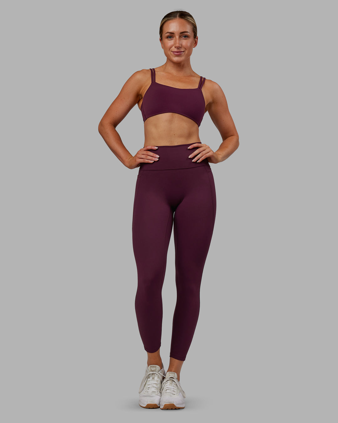 Woman wearing Fusion Ultra High-Rise 7/8 Legging Pockets - Cherry Lacquer | Model:Paris | Size:S