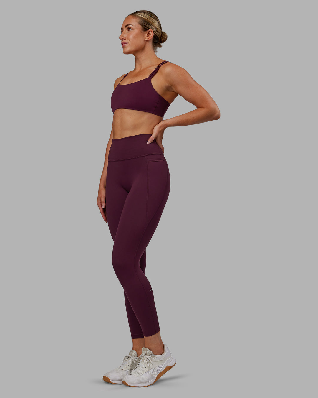 Woman wearing Fusion Ultra High-Rise 7/8 Legging Pockets - Cherry Lacquer | Model:Paris | Size:S
