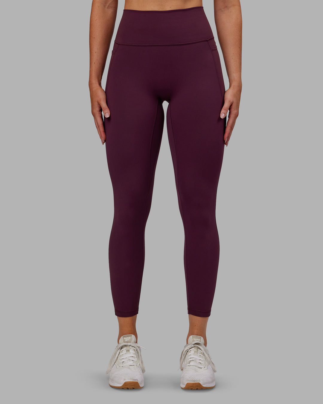 Woman wearing Fusion Ultra High-Rise 7/8 Legging Pockets - Cherry Lacquer | Model:Paris | Size:S