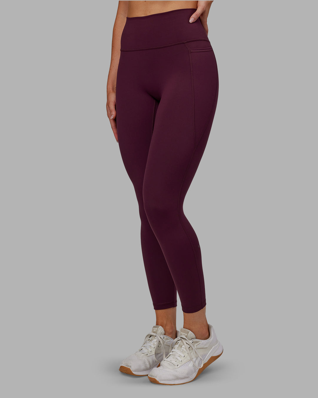 Woman wearing Fusion Ultra High-Rise 7/8 Legging Pockets - Cherry Lacquer | Model:Paris | Size:S