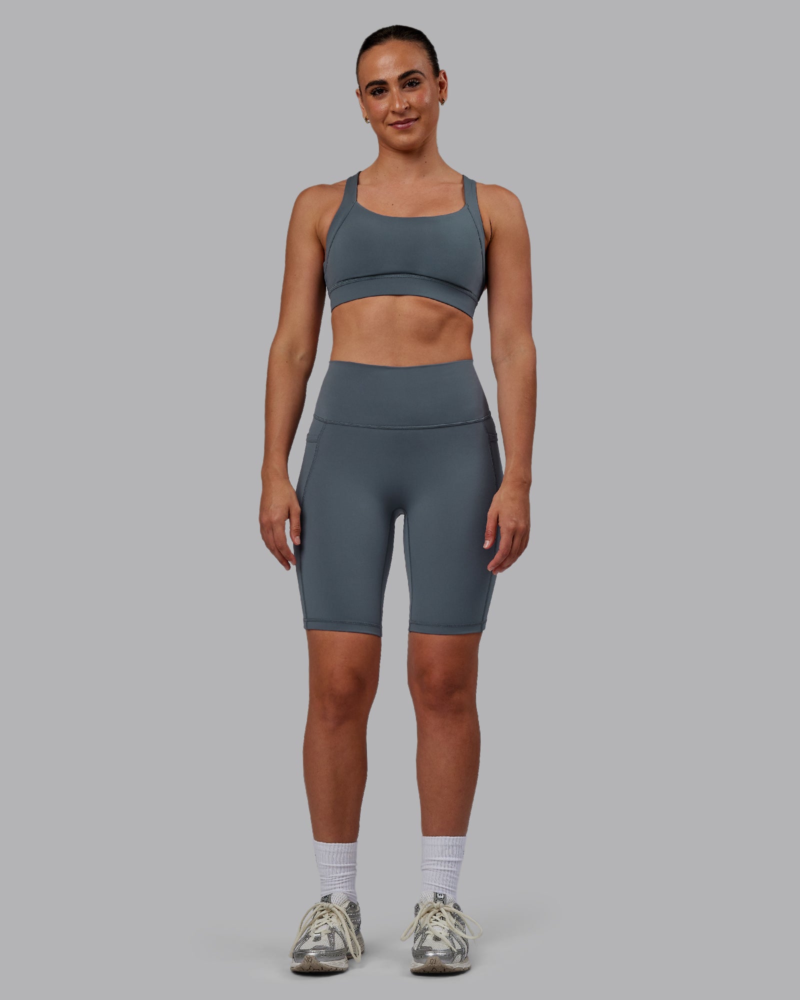 Woman wearing Fusion Ultra High-Rise 9" Short Pockets - Turbulence | Model:Sophie | Size:S
