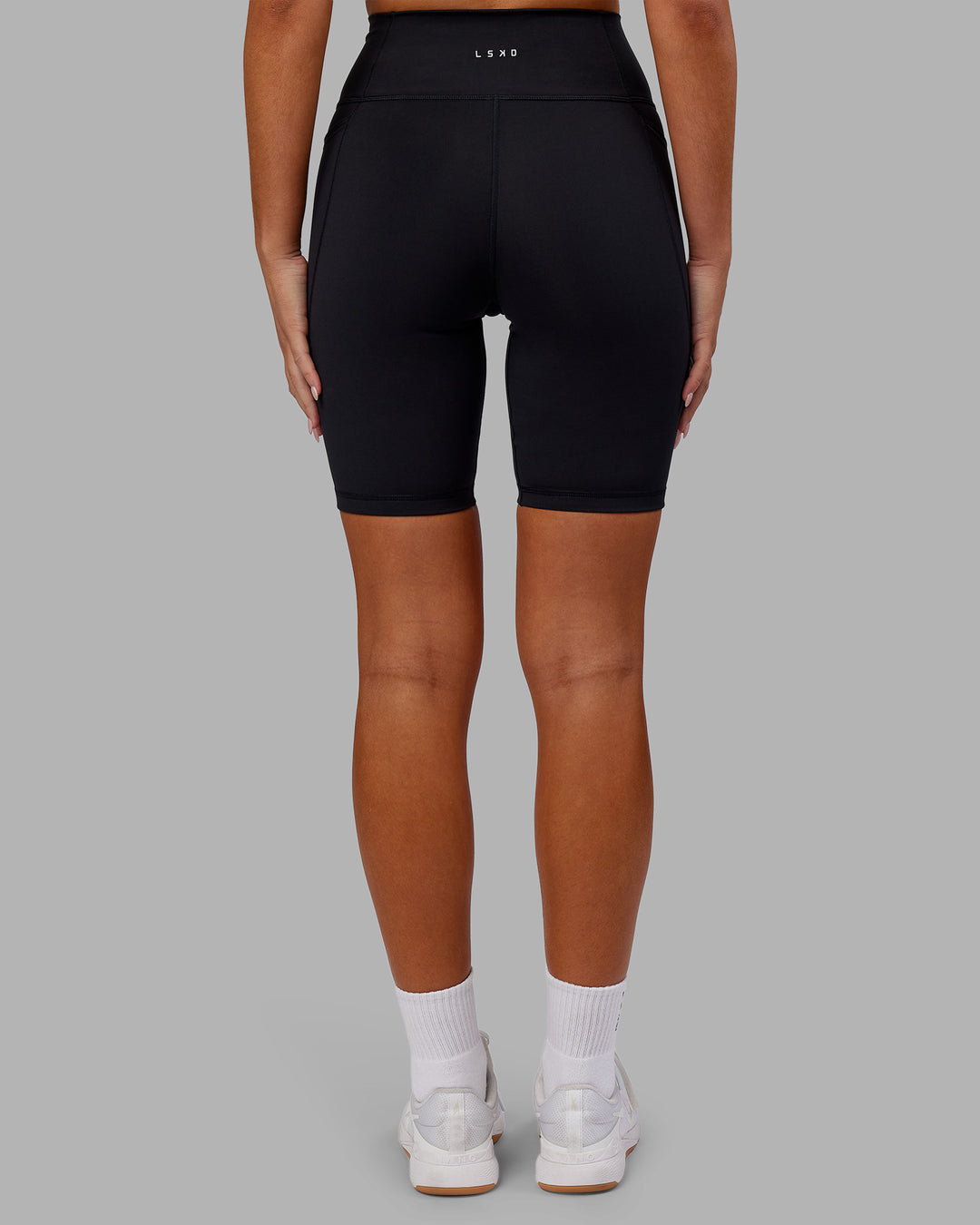 Woman wearing Fusion Ultra High-Rise 9&quot; Short Pockets - Black | Model:Kirstyn | Size:S