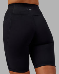 Woman wearing Fusion Ultra High-Rise 9" Short Pockets - Black | Model:Kirstyn | Size:S | Thumbnail Index: 6