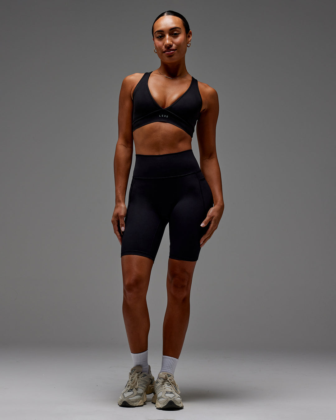Woman wearing Fusion Ultra High-Rise 9&quot; Short Pockets - Black | Model:Demi | Size:S