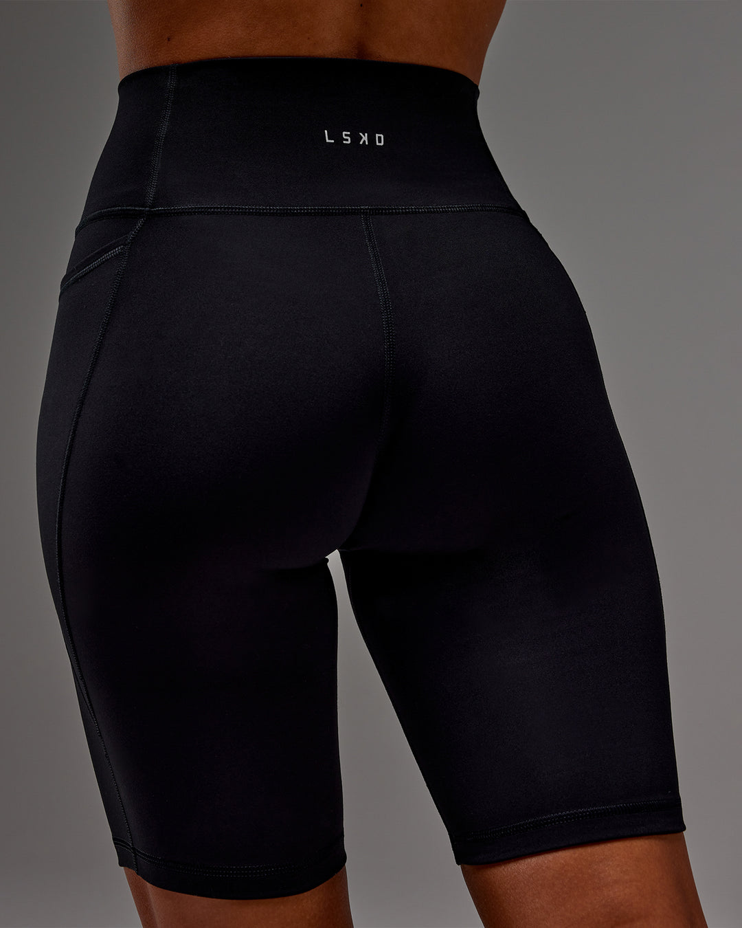 Woman wearing Fusion Ultra High-Rise 9&quot; Short Pockets - Black | Model:Demi | Size:S