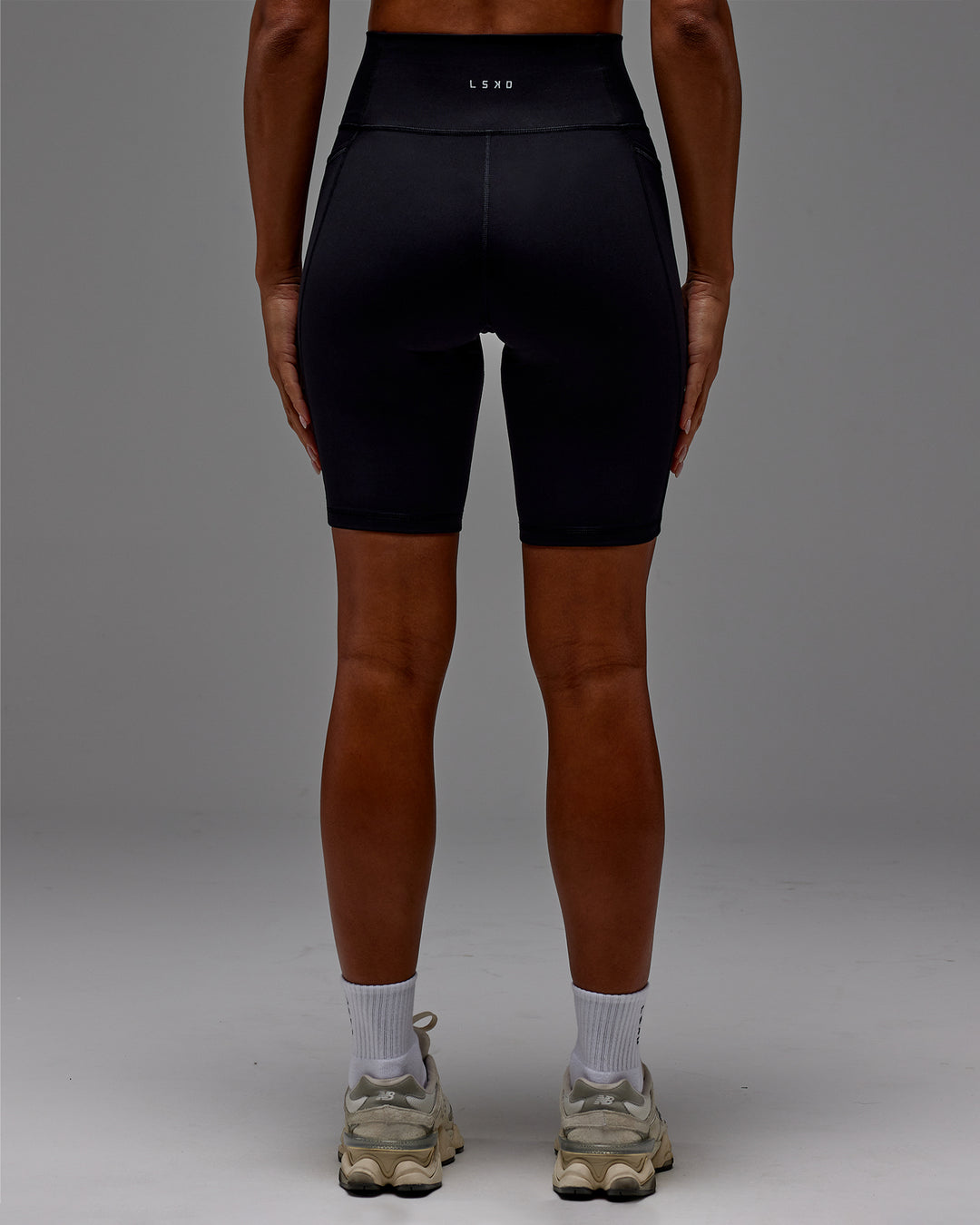 Woman wearing Fusion Ultra High-Rise 9&quot; Short Pockets - Black | Model:Demi | Size:S