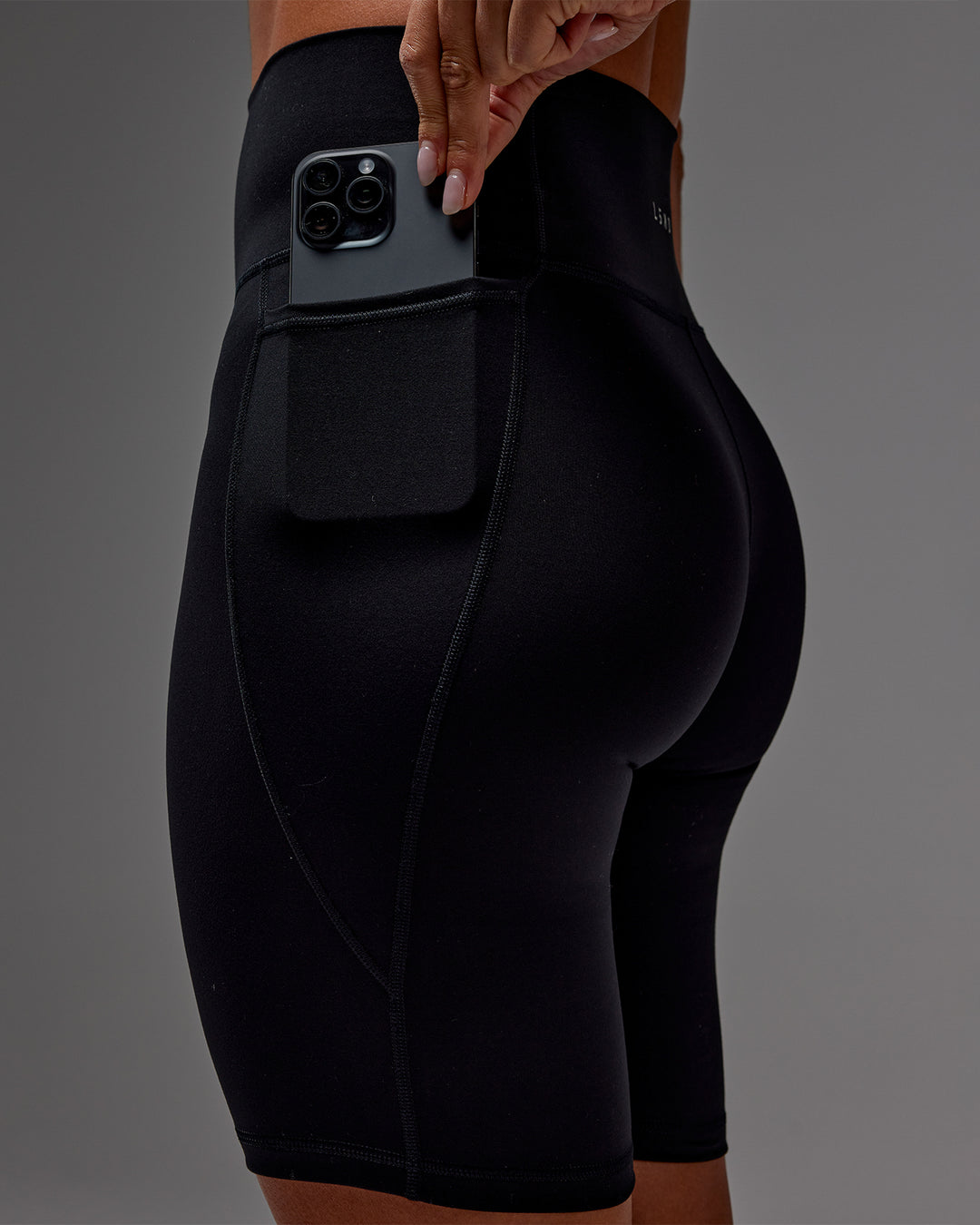 Woman wearing Fusion Ultra High-Rise 9&quot; Short Pockets - Black | Model:Demi | Size:S